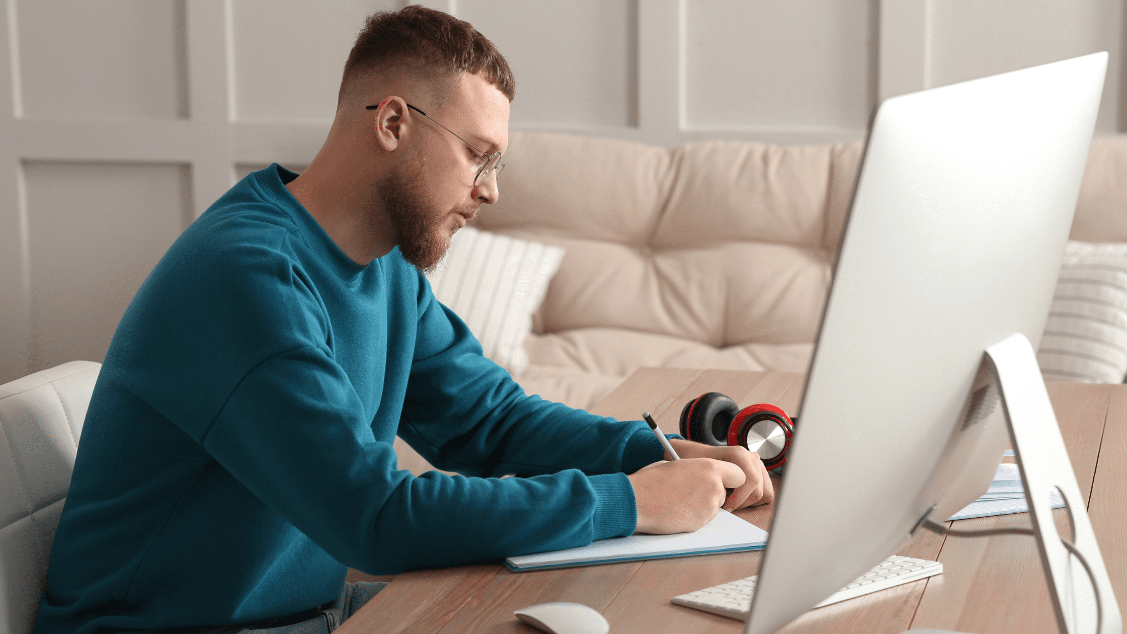 A medical school student taking an NBME practice test for USMLE prep in a living room in front of a desktop computer.